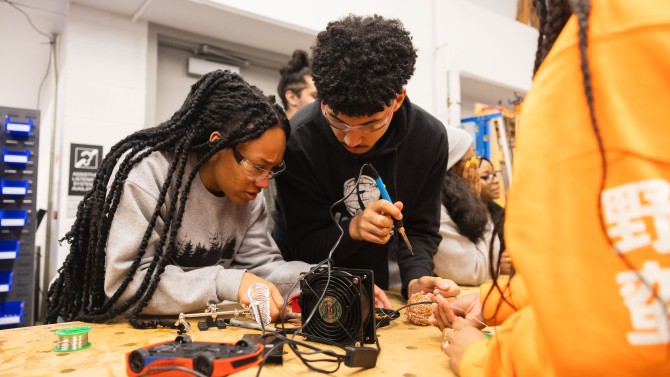 Students use a soldering iron to rewire a toy at one of many toy adapting sessions organized by the Big Red Adaptive Play and Design Initiative.