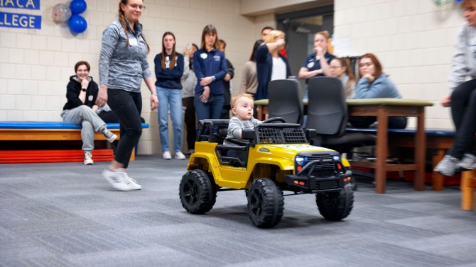 14-month-old Silas Hultberg test-drives his adapted toy car at the GoBabyGo event at Ithaca College on March 24.